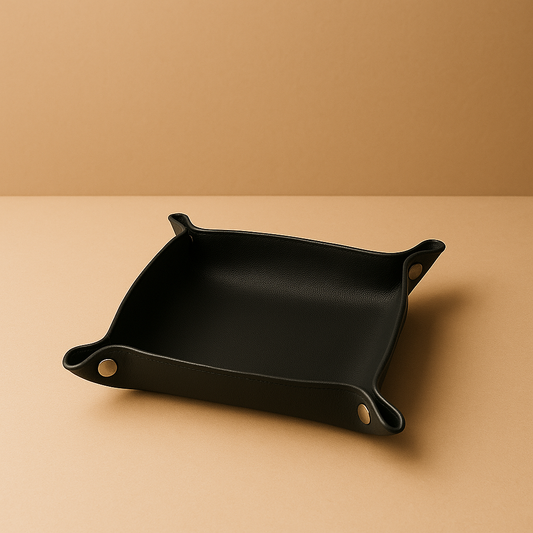 black leather tray standing on beige surface 