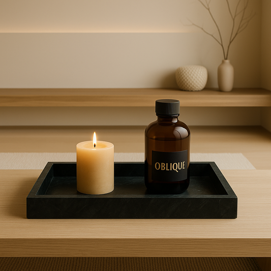 black marble tray with candle and luxurious oblique bottle standing on wooden table with luxurious living room background