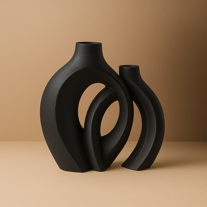 black round ceramic vase set standing on beige surface 